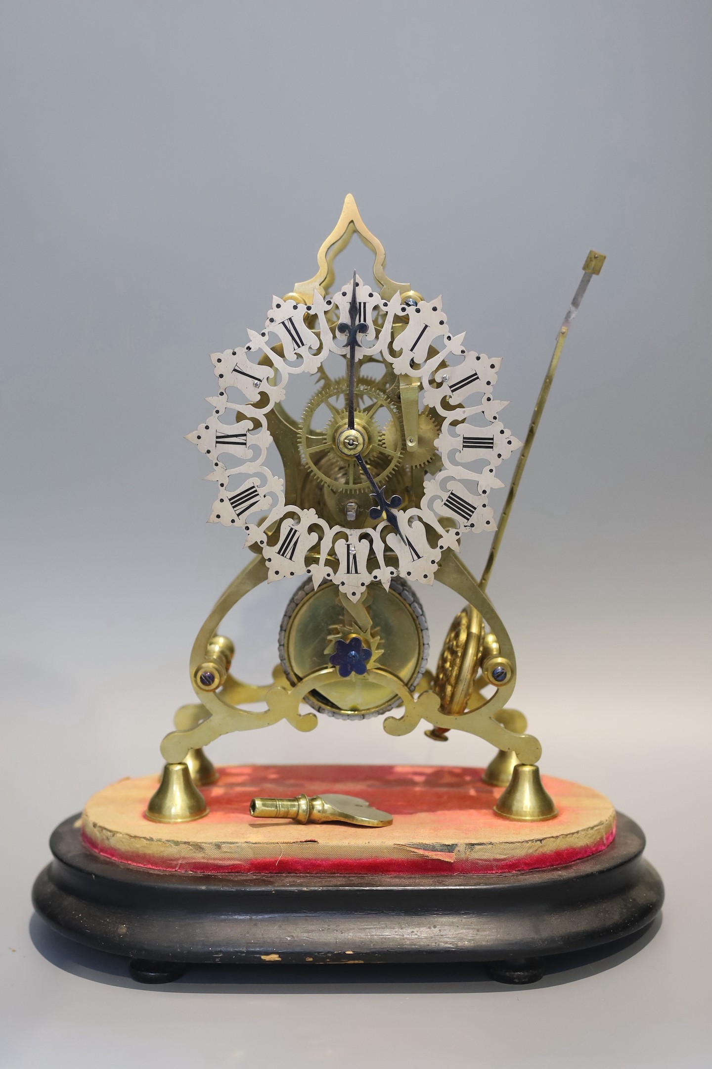 A 19th century brass skeleton mantel timepiece, under glass dome, with single fusee movement and pierced silvered chapter ring, height 24cm